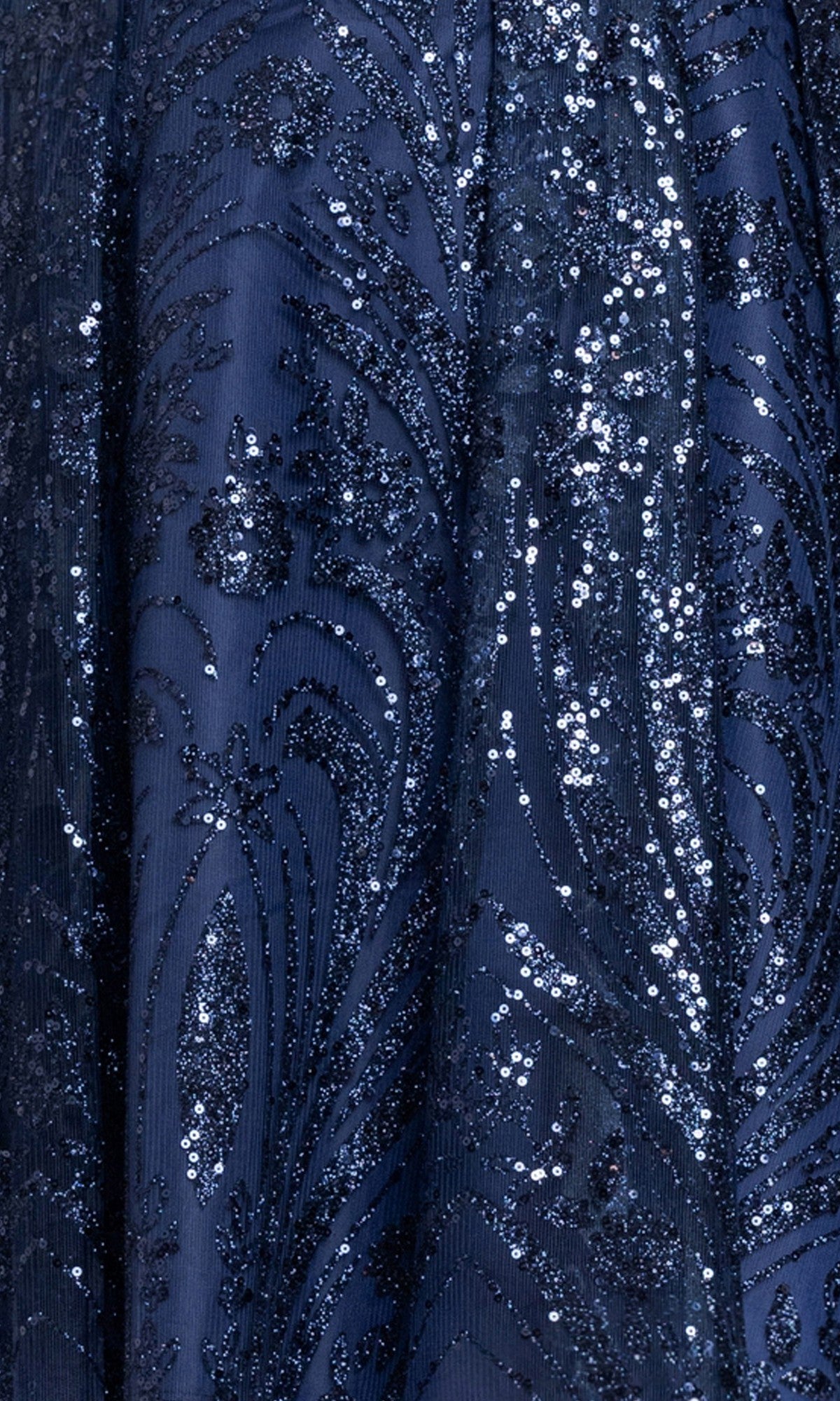 Close-up of the Plus-Size Navy Hoco Dress: Blondie Nites 6266BNW fabric, showcasing intricate swirling floral patterns adorned with glittering sequins and elegant embroidery.
